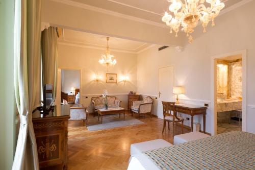 a bedroom with a bed and a table and a desk at Imperiale Palace Hotel in Santa Margherita Ligure