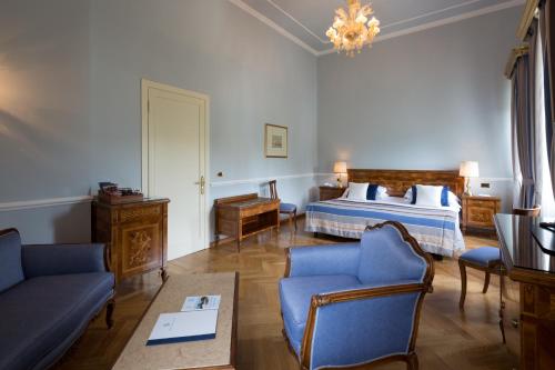a hotel room with a bed and a couch at Imperiale Palace Hotel in Santa Margherita Ligure