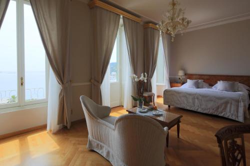 a bedroom with a bed and a table and a chair at Imperiale Palace Hotel in Santa Margherita Ligure