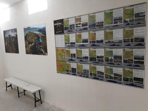 a bench in front of a wall with posters at Hotel Dos Rios Central in Aínsa