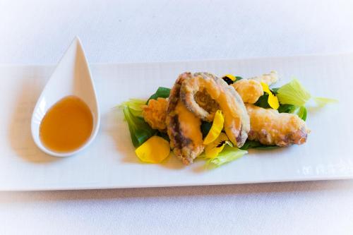 a plate of food with shrimp and a dipping sauce at Imperiale Palace Hotel in Santa Margherita Ligure