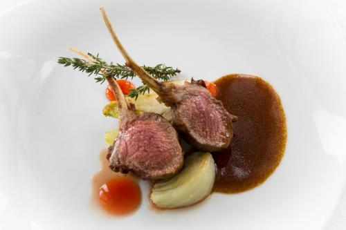 a meal of meat and vegetables on a white plate at Imperiale Palace Hotel in Santa Margherita Ligure