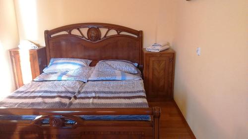 a bedroom with a wooden bed with a wooden frame at Apartament Europejskiej Stolicy Kultury in Wrocław