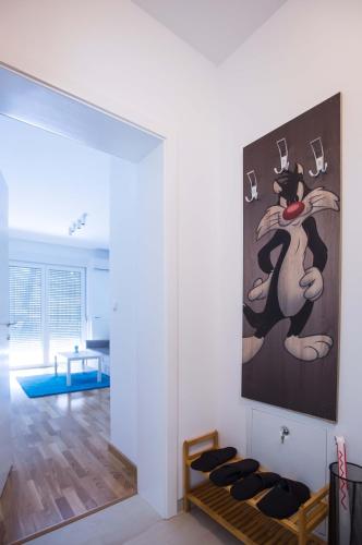 a living room with a painting on the wall at Jelena Apartment in Doboj