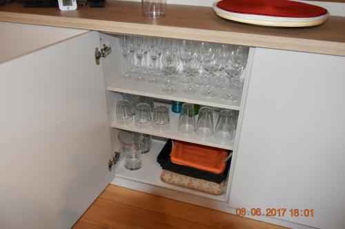 a cupboard with wine glasses in it at Damon II in Poelkapelle