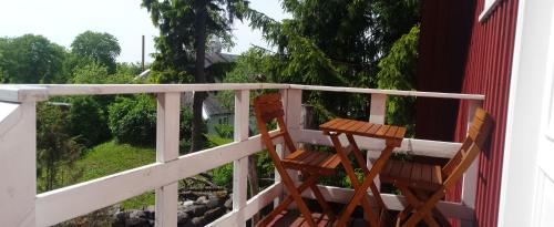 two chairs sitting on the porch of a house at Jurna Recreation Farm in Upa