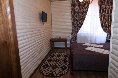 a small room with a bed and a window at Villa Nikoletta SPA in Bukovel