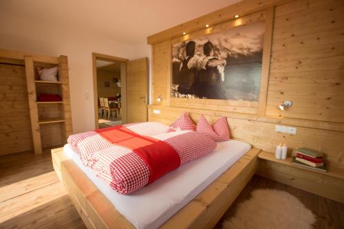 a bedroom with a bed in a wooden room at Herzl Hof in Zellberg