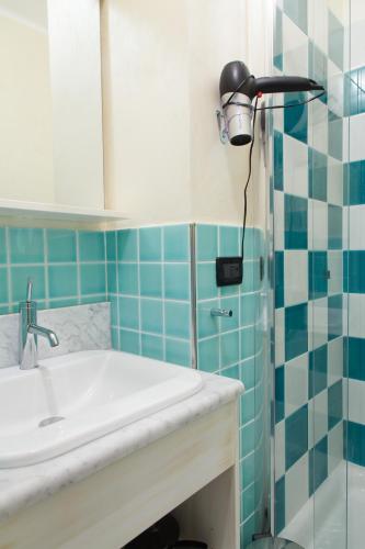 a bathroom with a sink and a shower at Allegroitalia Alassio Rosa in Alassio