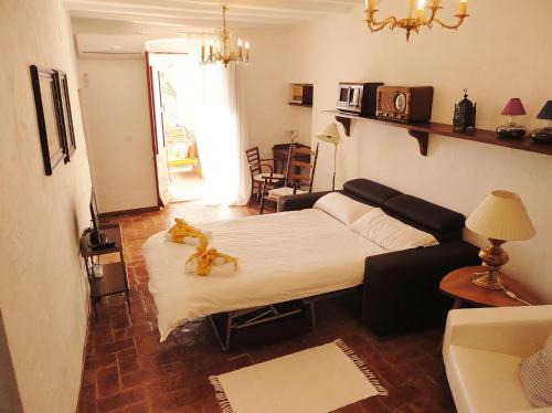 a living room with a bed and a couch at Can Barraca in Avinyonet de Puigventós