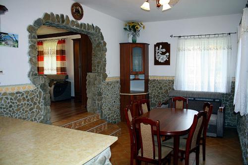 a living room with a table and a dining room at Dom Aga Bieszczady 10 osobowy in Bukowiec