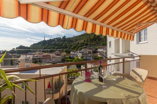 a balcony with a table and a view of a city at Apartments Garmaz in Podgora