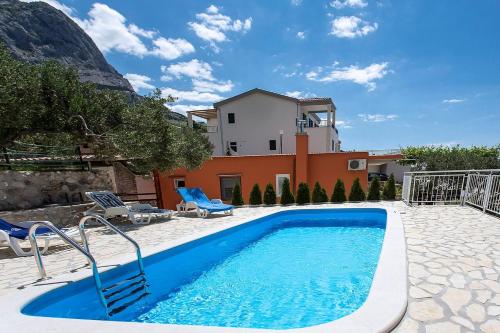 a swimming pool in front of a house at Holiday Home Chill Zone in Baška Voda
