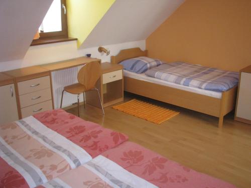 a small bedroom with a bed and a desk and a desk at Apartment Gaspercic in Bovec