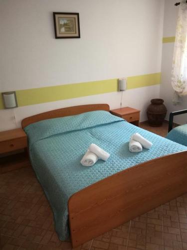 a bedroom with a bed with two towels on it at Apartment Djanina in Cres