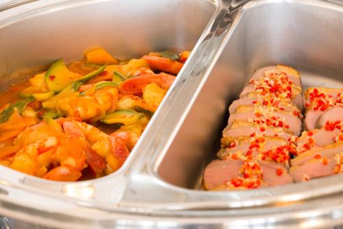 a container of food with meat and vegetables in it at Imperiale Palace Hotel in Santa Margherita Ligure
