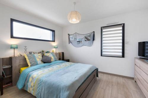 a bedroom with a bed and a television in it at Chez Aurelie in Saint-Alban