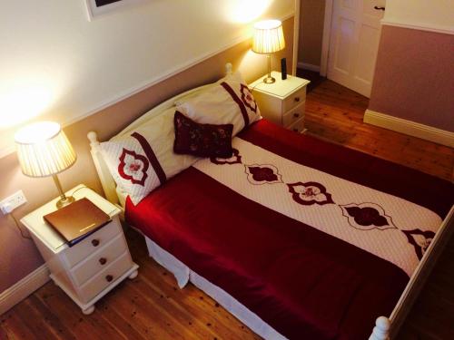 a bedroom with a bed with two night stands and two lamps at Clai Ban in Kilronan