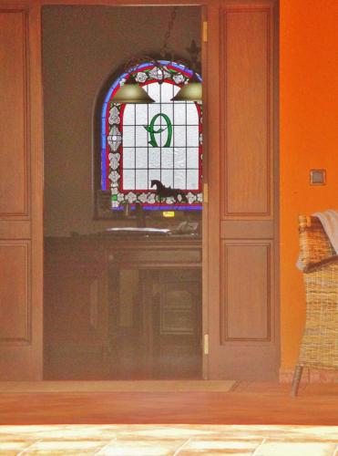 a door with a stained glass window in a room at Hotel Rural Yeguada Albeitar in Villayón
