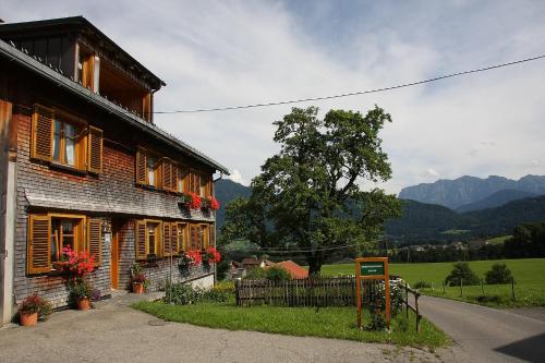a house with a fence in front of it at Ferienhof Metzler in Schwarzenberg im Bregenzerwald