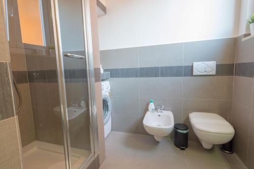 a bathroom with a shower and a toilet and a sink at Sea of ​​Rome near the center of the Eternal City! in Lido di Ostia