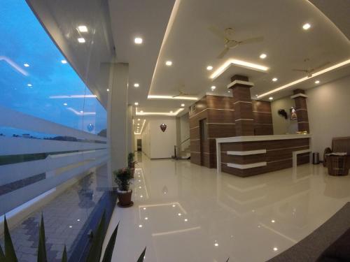 a lobby of a building with a view of the ocean at Alfa Inn in Nedumbassery