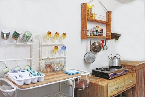 a kitchen with a wooden counter with pots and pans at Rumah Kita BnB in Yogyakarta