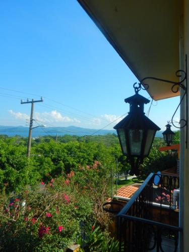 a lamp on the side of a house with a view at Posada Bugambilias in Catemaco