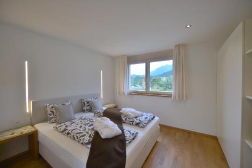 a living room with a couch and a window at Haus Kibitz in Fieberbrunn
