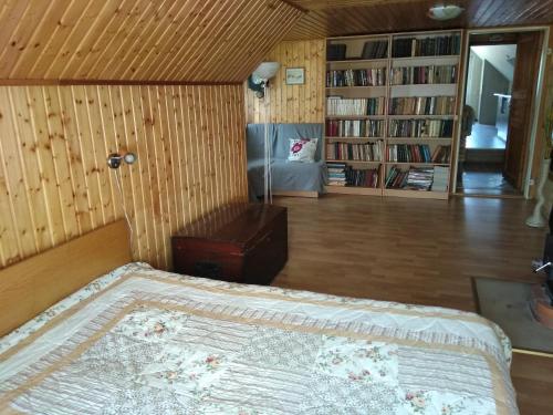 a bedroom with a bed and a book shelf at Narva-Jõesuu Apartment in Narva-Jõesuu
