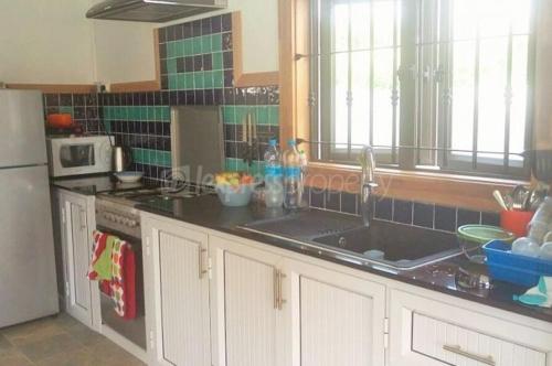 a kitchen with a sink and a counter top at Villa Kayana in Flic-en-Flac