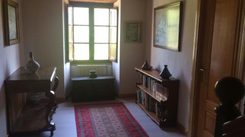 a living room with a book shelf and a window at Casa Firmo in Quintana