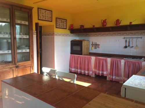 a kitchen with a table and chairs in a room at Casa Firmo in Quintana