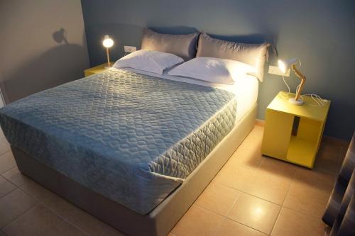 a bedroom with a large bed with a blue wall at Evaris Apartments in Chania Town