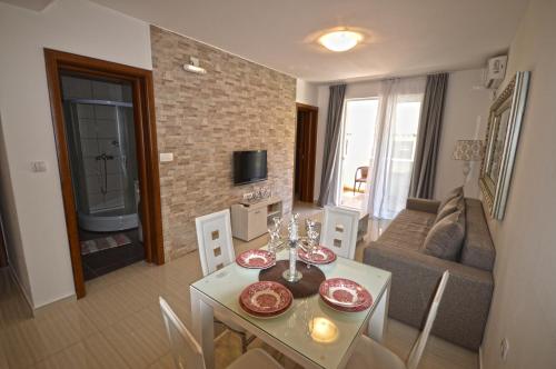a living room with a table and a couch at Apartmani Kovačević in Kotor