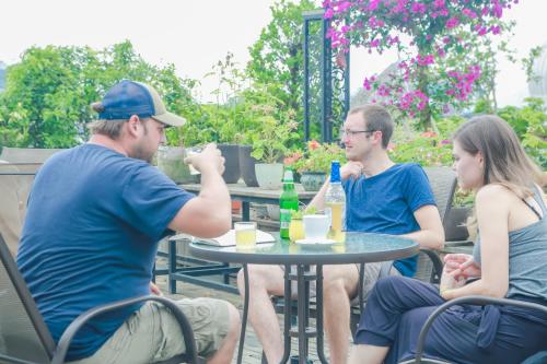 a group of three people sitting around a table at Sky Garden Inn in Guilin