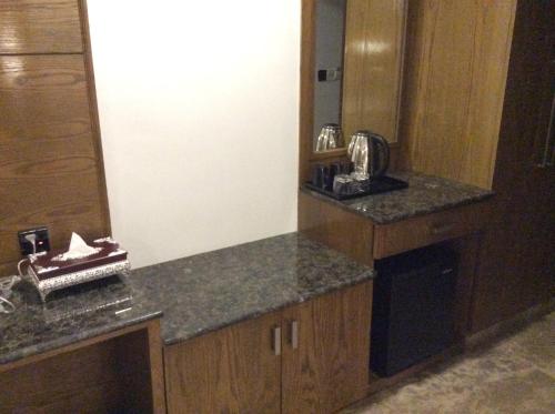 a kitchen with a counter top and a mirror at Marino Royal Hotel in Dhaka