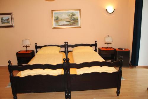 a bedroom with two beds and two lamps on tables at Osteria Battello in Caslano
