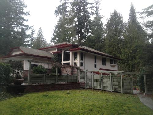 a small house with a fence in the yard at StudioOne Pebble Beach in Powell River