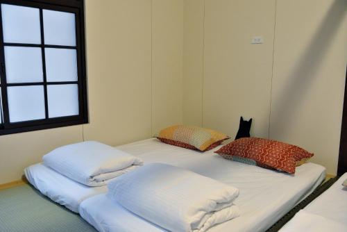 Postel nebo postele na pokoji v ubytování 爪窩 29 Nesuto