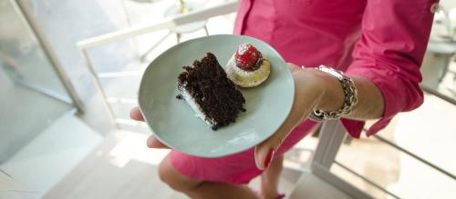 a person holding a plate with a piece of cake at B&B Panorama Cinque in Salò