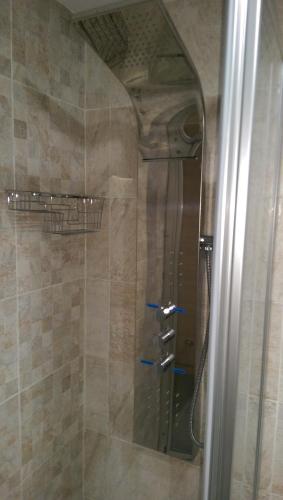 a shower with a glass door in a bathroom at Pensión Araba II in Vitoria-Gasteiz