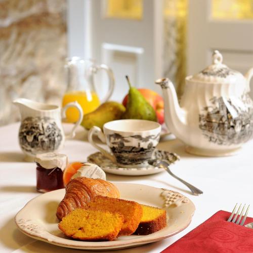 ein Tisch mit einem Teller Brot und einer Tasse Kaffee in der Unterkunft Hotel Boutique Casona del Boticario in San Vicente de la Sonsierra