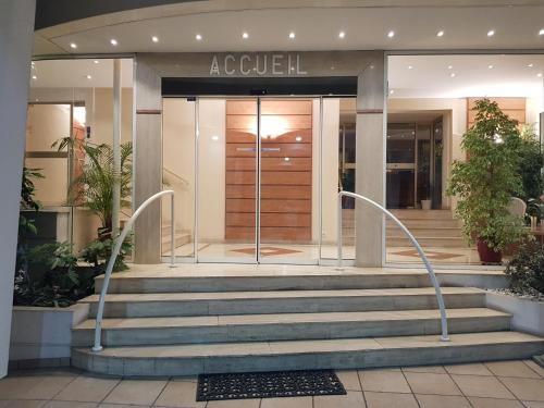 a lobby with stairs in front of a building at Apartments at Commodoro in Villeneuve-Loubet