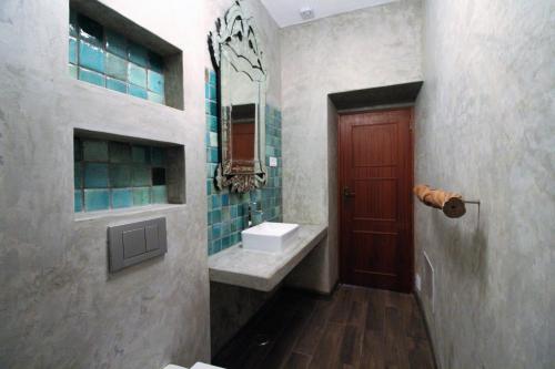 a bathroom with a sink and a red door at Casa Rocha in Albufeira