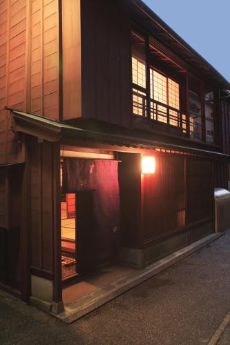 a building with an open door with a light in it at Machiya Kanazawa Kikunoya in Kanazawa