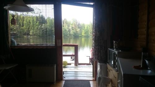 a door leading into a room with a view of a lake at Lohja Chalet at Lake Enäjärvi in Karjalohja
