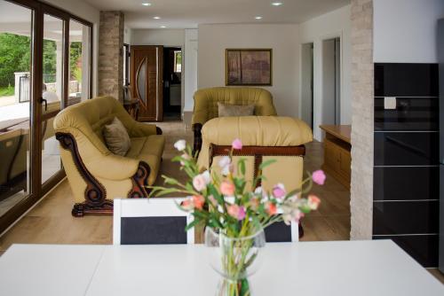 a living room with a vase of flowers on a table at Villa Karla in Međugorje