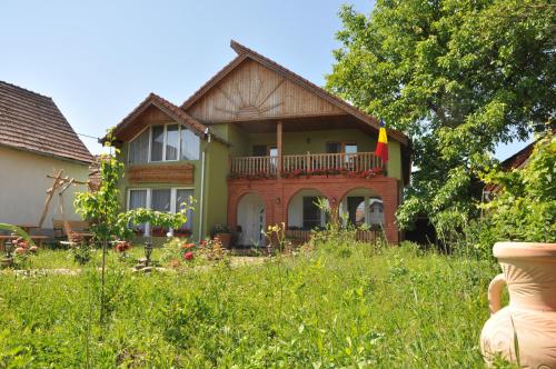 a house with a flag on the front of it at Pensiune Muzeu Traditional Poveste in Transilvania in Sighişoara