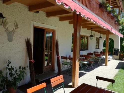 a patio of a restaurant with tables and chairs at Hotel-Restaurant Zum Hirschhaus Inklusiv Chiemgaukarte in Ruhpolding